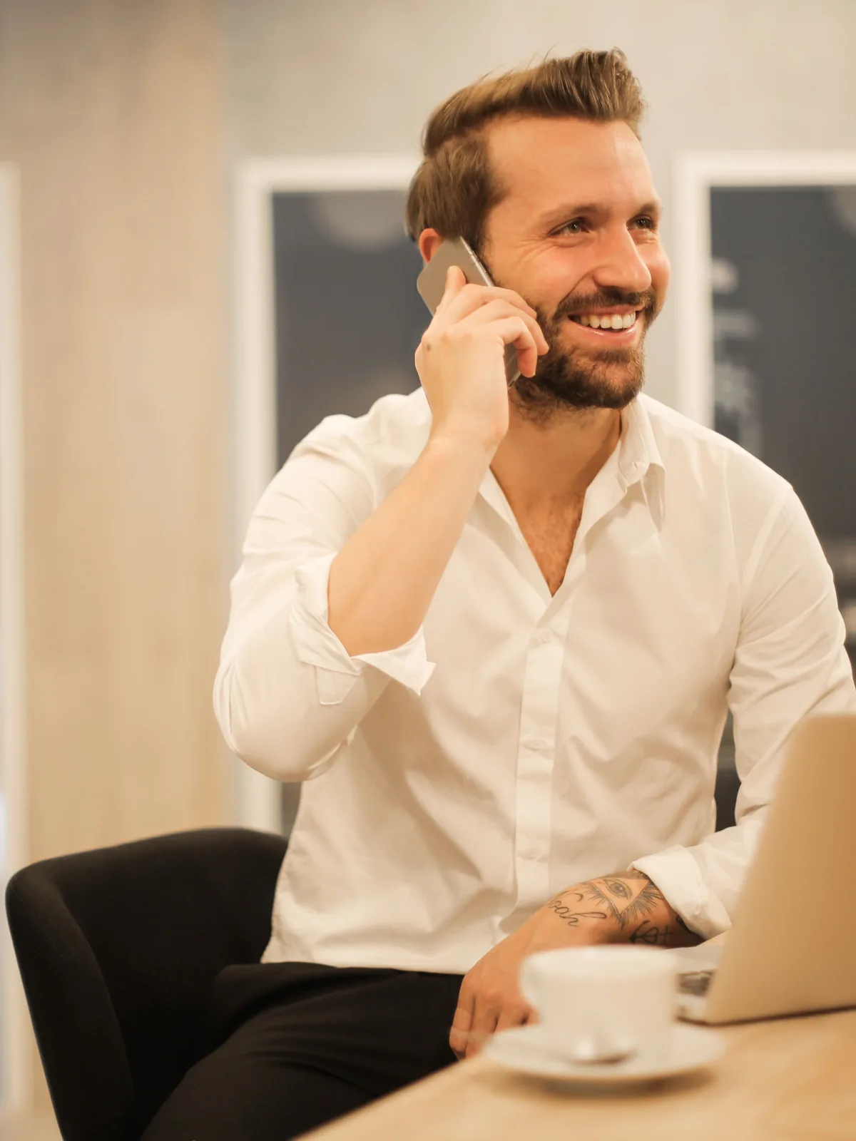 Taking a call beside a laptop