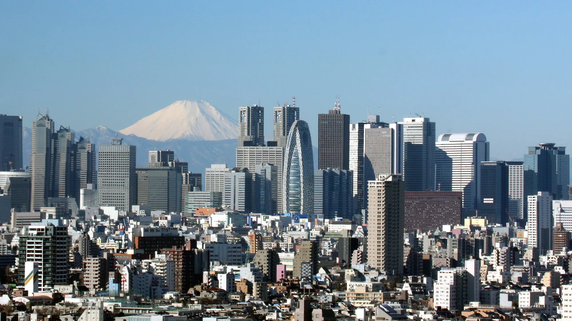 The Shinjuku skyline in Tokyo with Mount Fuji behind it